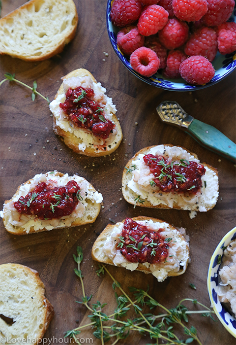 Smashed Raspberry and Goat Cheese Crostinis by Maren Swanson. #appetizer #recipe #goatcheese #raspberry #crostini@lovehappyhour